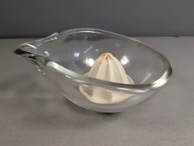 Sale Photo Thumbnail #316: Vintage glass citrus juicer with a white ceramic reamer cone and pour spout.
