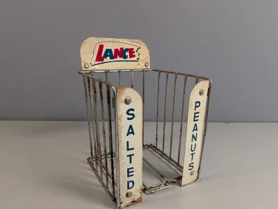 Sale Photo Thumbnail #256: Vintage Lance Salted Peanuts countertop wire display rack, showing original painted metal branding and heavy age-appropriate patina and rust.