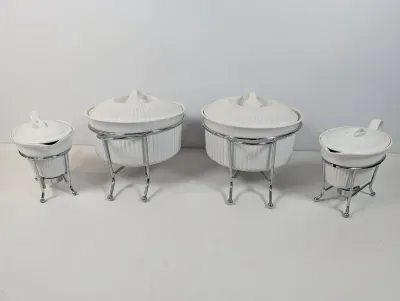 Sale Photo Thumbnail #135: Four-piece set of white ribbed ceramic chafing dishes and sauce warmers with matching chrome wire stands.