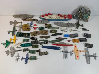 Sale Photo Thumbnail #113: Large collection of vintage plastic and die-cast military toys, including airplanes, tanks, battleships, submarines, and a bag of plastic army men.