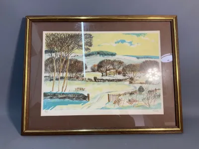 Sale Photo Thumbnail #76: Framed mid-century limited edition landscape print depicting a snowy countryside scene, presented in a wood frame with gilt accent detailing.