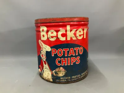 Sale Photo Thumbnail #353: Vintage Becker Potato Chips tin from Becker Pretzel Bakeries of Columbia, PA, featuring classic red and blue graphics with a chef illustration, showing age-appropriate surface wear and scratching.