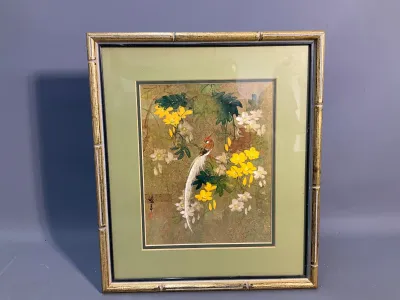 Sale Photo Thumbnail #77: Framed Asian watercolor and feather collage artwork depicting a long-tailed bird among yellow and white blossoms, set in a faux-bamboo gilt frame.