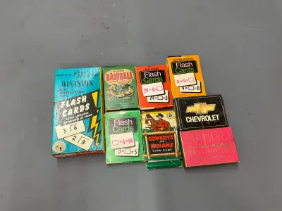Sale Photo Thumbnail #360: Collection of vintage card games and math flash cards, including Ed-U-Cards and a Chevrolet playing card deck, showing light edge wear.