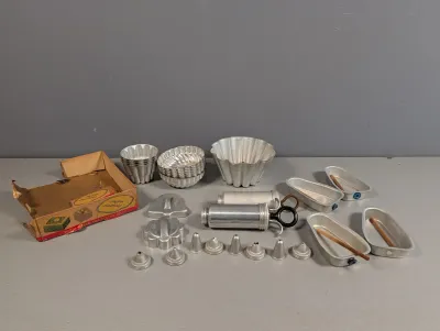 Sale Photo Thumbnail #175: Vintage Mirro aluminum cake decorator set and baking molds, complete with original box, press attachments, pastry tips, and fluted gelatin tins.
