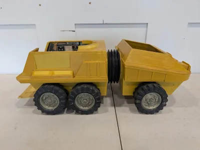 Sale Photo Thumbnail #493: Vintage Remco Mighty Mike sci-fi articulated radar truck toy, crafted in yellow plastic with rubber tires.