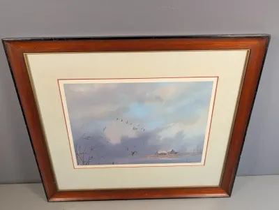 Sale Photo Thumbnail #23: Framed waterfowl art print featuring ducks in flight over a wetland landscape, set in a double mat and warm wood frame.