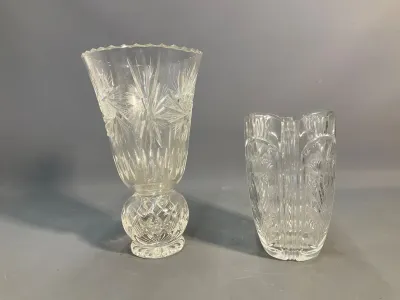 Sale Photo Thumbnail #59: Pair of cut glass vases, including a footed trumpet vase with pinwheel patterns and a cylindrical vase with floral motifs.