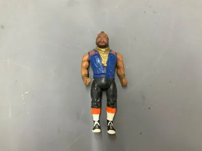 Sale Photo Thumbnail #341: Vintage 1980s Mr. T action figure by Galoob, featuring his signature gold chains, blue vest, and boots with minor paint wear.