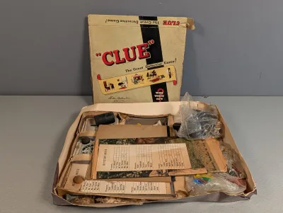 Sale Photo Thumbnail #227: Vintage Parker Brothers Clue board game, circa 1950s, complete with original box, game board, detective score pads, and pieces in worn condition.