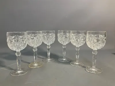 Sale Photo Thumbnail #87: Set of six cut crystal wine goblets with intricate crisscross and fan detailing on faceted stems.