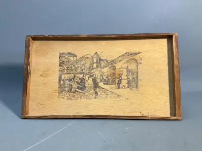 Sale Photo Thumbnail #167: Vintage rectangular wooden tray featuring a printed black and white illustration of a traditional Mexican village scene with dancers and architecture.
