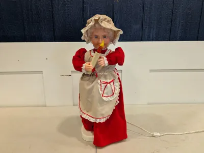 Sale Photo Thumbnail #479: Vintage Telco Motion-ette Mrs. Claus illuminated Christmas figure holding a candle, dressed in a red gown with lace apron and bonnet.