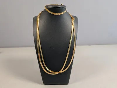 Sale Photo Thumbnail #403: Gold-tone herringbone flat chain necklaces displayed on a black jewelry bust.