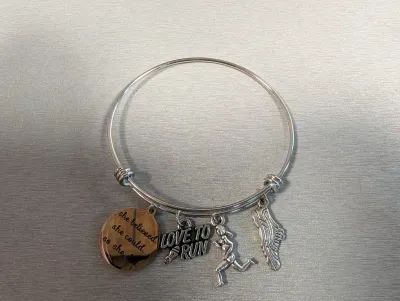 Sale Photo Thumbnail #6: Silver-tone running-themed expandable bangle bracelet with charms including a runner, running shoe, 'Love to Run', and an inspirational quote disc.