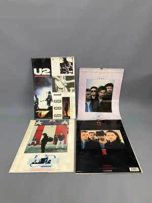 Sale Photo Thumbnail #351: Collection of four vintage U2 band wall calendars spanning 1987 to 1989, featuring iconic photography of the band.