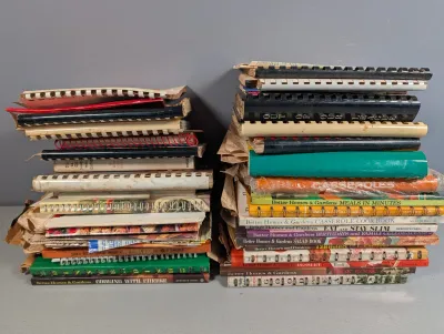 Sale Photo Thumbnail #299: Two stacks of vintage spiral-bound and hardcover cookbooks, including several Better Homes & Gardens titles.