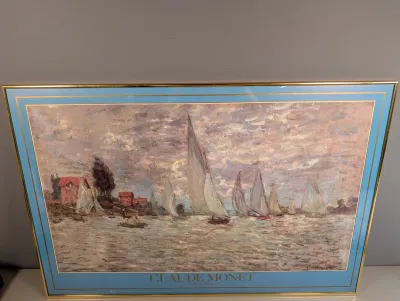 Sale Photo Thumbnail #21: Framed exhibition poster featuring Claude Monet's Regatta at Argenteuil, double-matted in light blue and set in a thin gold-tone metal frame.