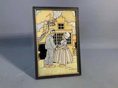 Sale Photo Thumbnail #159: Framed Art Deco reverse-painted foil or mother-of-pearl glass picture depicting a Dutch couple, signed Smith Frederics in lower right corner.