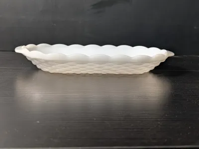 Sale Photo Thumbnail #498: Vintage white milk glass oblong dish featuring a basketweave texture and scalloped rim.
