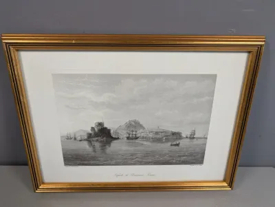 Sale Photo Thumbnail #424: Framed antique black and white engraving depicting "Napoli di Romania, Greece," featuring a coastal view with ships and fortifications, set in a white mat and gold-toned wooden frame.