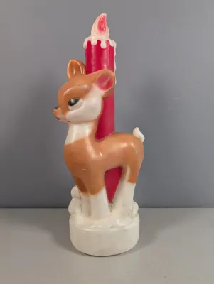 Sale Photo Thumbnail #430: Vintage plastic Christmas blow mold deer figure with an integrated candle-shaped light feature.