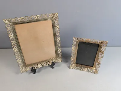 Sale Photo Thumbnail #408: Pair of vintage ornate gold-tone filigree metal picture frames in varying sizes.