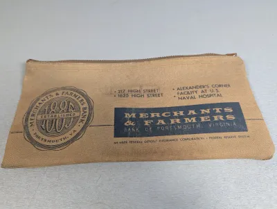 Sale Photo Thumbnail #321: Vintage canvas zippered bank deposit bag from Merchants & Farmers Bank of Portsmouth, Virginia, featuring printed logos and branch locations.