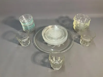 Sale Photo Thumbnail #63: Collection of clear glassware, including stacked small bowls, a cake platter with salad plates, and etched tumbler glasses.