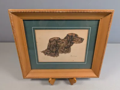 Sale Photo Thumbnail #458: Framed vintage art print featuring a pair of Gordon Setters signed by artist Paul Wood, housed in a beaded light wooden frame with green matting.