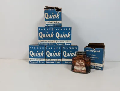 Sale Photo Thumbnail #98: Collection of vintage Parker Quink permanent brown ink boxes alongside one glass bottle featuring the original label.