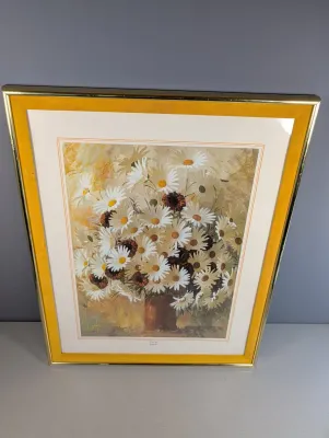 Sale Photo Thumbnail #460: Framed floral print featuring a still life of daisies, housed in a vintage yellow and gold-tone frame.