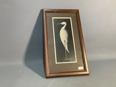 Sale Photo Thumbnail #166: Framed original painting of a white egret against a black background, signed by artist B. Paul Fisher and set in a dark wood frame.