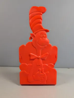 Sale Photo Thumbnail #429: Vintage red plastic Dr. Seuss The Cat in the Hat napkin or mail holder, showing light surface wear.