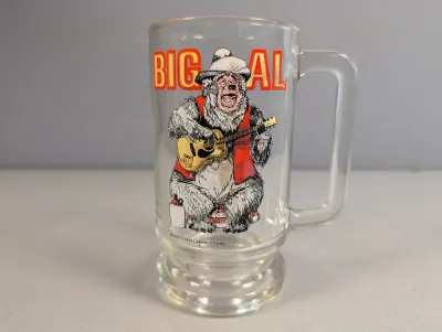 Sale Photo Thumbnail #411: Vintage Disney Country Bear Jamboree clear glass mug featuring Big Al playing guitar, in good condition.
