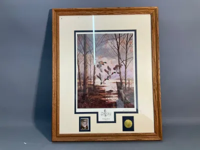 Sale Photo Thumbnail #84: Framed and matted wildlife art print depicting mallard ducks in flight over a marshland, titled "Easing Down" by Bill Pendergrass. Features double matting with a small inset stamp and medallion, presented in a molded oak frame.