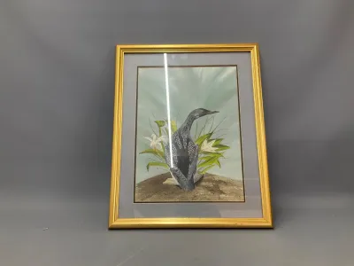 Sale Photo Thumbnail #72: Framed artwork depicting a loon amongst aquatic foliage, presented with double matting in a gilded frame.