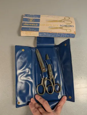 Sale Photo Thumbnail #219: Vintage Sheffield Golden Age two-piece scissor set in a blue vinyl carrying case, complete with the original box.