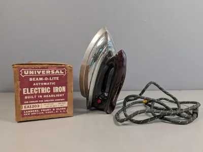 Sale Photo Thumbnail #187: Vintage Universal Beam-O-Lite automatic electric iron model EA1203, complete with its original fabric cord and box by Landers, Frary & Clark.