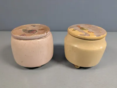 Sale Photo Thumbnail #388: Pair of vintage turned-wood trinket boxes with painted finishes and worn decal detailing on the lids.