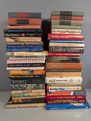 Sale Photo Thumbnail #267: Two tall stacks of assorted vintage and contemporary hardcover and paperback books covering fiction, self-help, and gardening.
