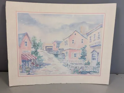 Sale Photo Thumbnail #25: Matted watercolor art print featuring a pastel street scene with pink and blue buildings, mounted on a textured cream board.