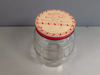 Sale Photo Thumbnail #196: Vintage clear glass pickle-barrel store jar featuring an original tin screw-on lid for Bradley's Candy Mfg. Co.