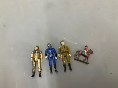 Sale Photo Thumbnail #352: Collection of small vintage toy figurines including military personnel, a ninja, and a cowboy on horseback, showing minor paint wear.