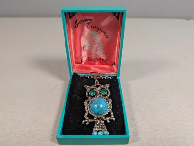 Sale Photo Thumbnail #405: Vintage owl pendant necklace featuring faux turquoise and green rhinestones, presented in an original turquoise plastic display box by Kochina.