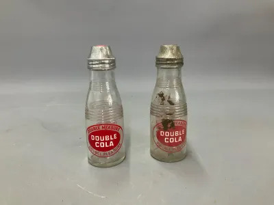 Sale Photo Thumbnail #345: Vintage pair of Double Cola glass salt and pepper shakers featuring red double measure logo graphics and metal caps.