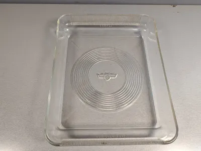 Sale Photo Thumbnail #245: Vintage clear glass refrigerator tray featuring a molded circular pattern and central emblem.
