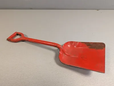 Sale Photo Thumbnail #255: Vintage short-handled metal hand shovel painted red, showing light rust and surface wear.