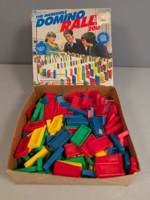 Sale Photo Thumbnail #305: Vintage 1980s The Incredible Domino Rally 200 game set in its original box with colorful plastic dominoes.