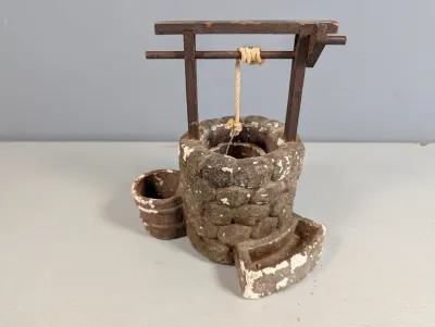 Sale Photo Thumbnail #179: Vintage miniature wished well planter or ornament made of molded composite stone and wood, featuring rustic painted details with some chippy paint wear.